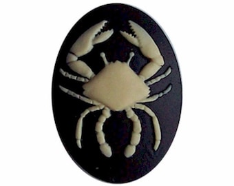 May include: A white crab silhouette on a black oval background.