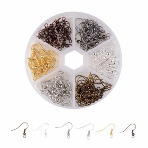 May include: A set of earring hooks in a plastic container with six compartments. The hooks are in five different colors: gold, silver, bronze, black, and gunmetal. Each compartment is filled with a different color of hooks.