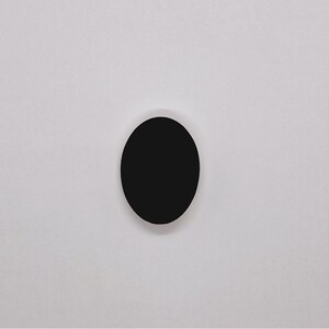 May include: A black circle on a white background.