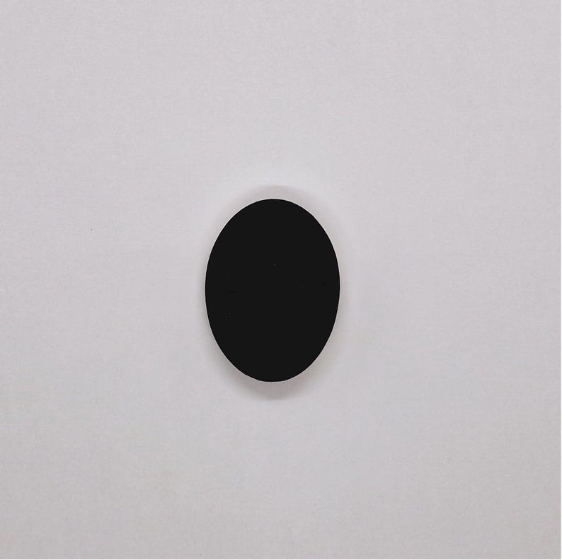 May include: A black circle on a white background.