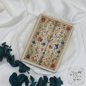 May include: A rectangular case with a cream-colored border and a detailed floral pattern in red, blue, and gold. The design features stylized flowers and birds on a cream background. The case is likely for a tablet or e-reader.