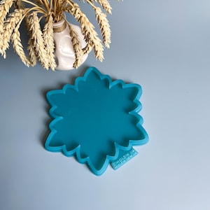 Pu&ograve; includere: Uno stampo in silicone turchese a forma di fiore. Lo stampo ha un bordo smerlato e si trova su una superficie azzurra. Un piccolo vaso bianco con spighe di grano &egrave; sullo sfondo. Il testo "MOLDIK.UA MOLDIK.COM.UA" &egrave; stampato sullo stampo.