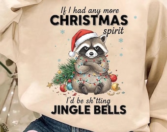 May include: Beige sweatshirt featuring a raccoon in a Santa hat and Christmas lights. The text says "If I had any more CHRISTMAS spirit I'd be sh*tting JINGLE BELLS". The design includes Christmas ornaments and a small Christmas tree.