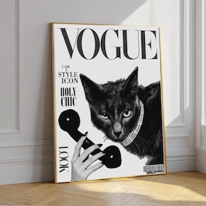 May include: Black and white Vogue magazine cover art featuring a black cat wearing a pearl necklace and holding a vintage telephone. The text includes "VOGUE", "I AM A STYLE ICON", and "HOLY CHIC". The artwork is framed in gold.