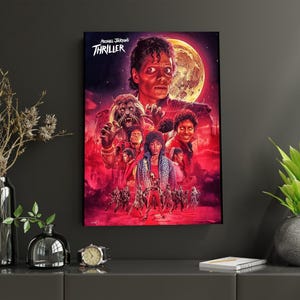 May include: A framed poster of Michael Jackson's Thriller album art. The artwork is predominantly red, with a large moon in the background. The poster features images of Michael Jackson and other characters from the music video.