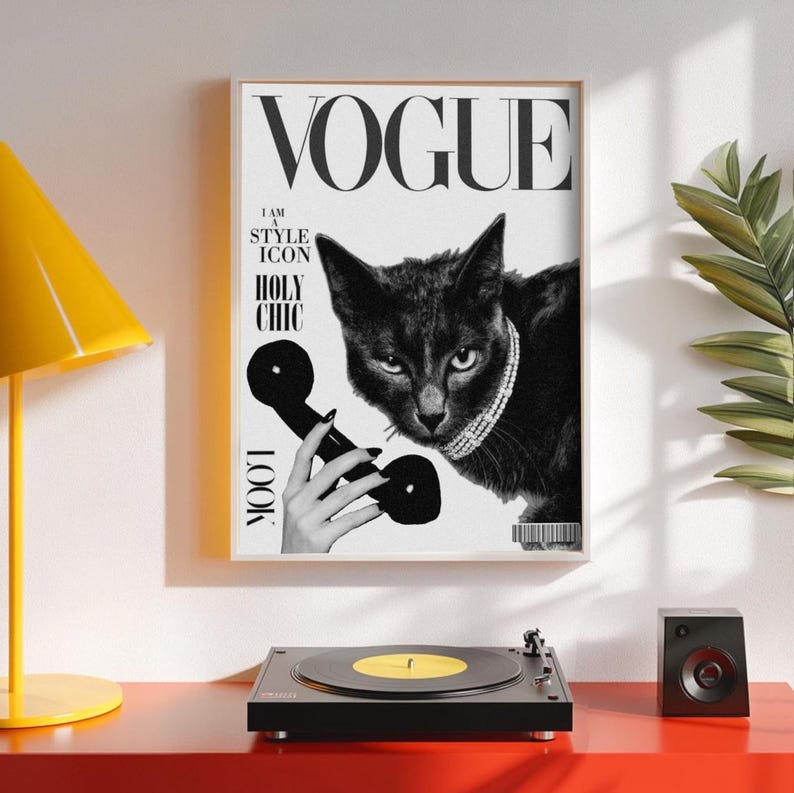 May include: A framed black and white Vogue magazine cover featuring a black cat wearing a jeweled collar and holding a vintage telephone receiver. The cover includes the Vogue logo and the words "I AM A STYLE ICON" and "HOLY CHIC".