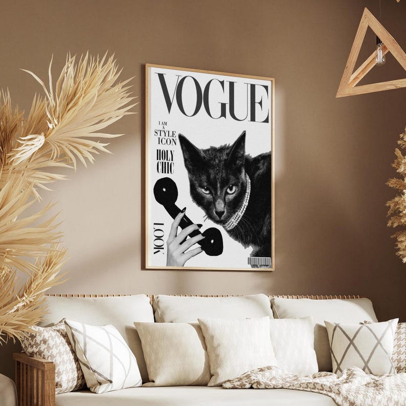 May include: A framed Vogue magazine cover featuring a black cat wearing a jeweled collar and holding a vintage telephone receiver. The cover includes the Vogue logo and the words "I AM A STYLE ICON HOLY CHIC LOOK". The image is in black and white.