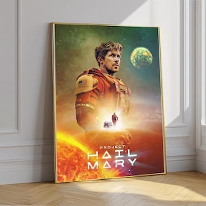 May include: A framed poster featuring a man in a space suit, with the text "PROJECT HAIL MARY." The artwork has a space theme, with a planet and a fiery sun in the background. The poster is in a gold frame.