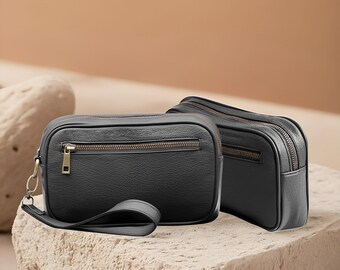 Bolso de mano Cardiff de piel premium para hombre en negro. Organizador de tecnología minimalista de mano. Elegante bolso de mano de viaje para hombre.