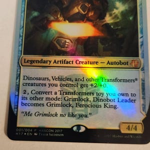 May include: A white ceramic mug with a black handle and the text "But first, coffee" in a handwritten style. The mug is on a white surface. The mug is approximately 4 inches tall.