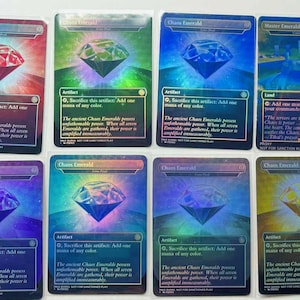 May include: A collection of Magic: The Gathering trading cards featuring the "Chaos Emerald" and "Master Emerald Shrine" cards. Each card displays a gemstone graphic with text describing its function. The cards have a holographic finish.