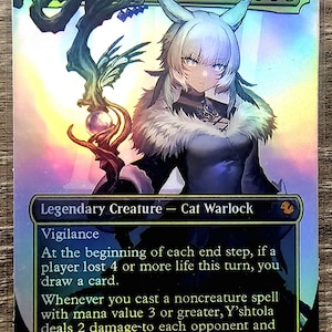 May include: A holographic trading card featuring Y'shtola, Night's Blessed, a Legendary Creature Cat Warlock. The card has a detailed illustration of a character with cat-like features. The card includes game text and a 2/4 power/toughness rating.