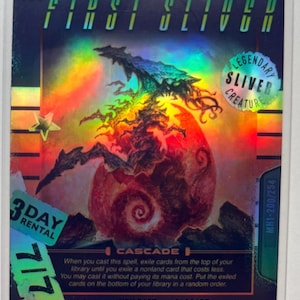 May include: A holographic trading card featuring "The First Sliver" with a creature illustration. The card has text including "Legendary Sliver Creature" and "Cascade." The card also has a "3 Day Rental" sticker and the number "7/7."