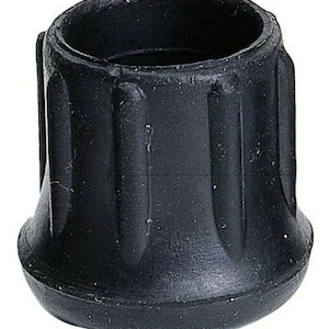 May include: A black rubber cane tip with a ridged exterior. The tip has a flared base and a cylindrical opening at the top. The rubber appears to be slightly textured.