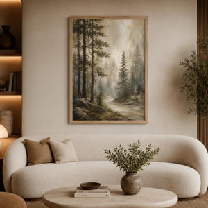 May include: A framed vertical wall art print depicting a misty forest landscape with tall pine trees, rocky terrain, and a flowing stream in muted earth tones of green, brown, and beige, displayed in a light-colored wooden frame.