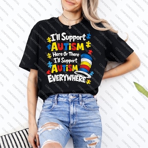 May include: Black t-shirt with the text "I'll Support AUTISM Here Or There I'll Support AUTISM EVERYWHERE" in colorful letters and puzzle piece graphics. The shirt features a design of a hat with red, yellow, and blue stripes.