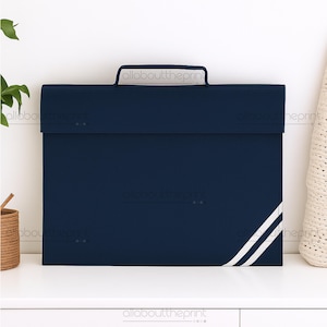 May include: A navy blue portfolio case with a white handle and two diagonal white stripes on the lower right corner. The case is rectangular and appears to be made of a sturdy material. The words "allabouttheprint" are printed on the case.