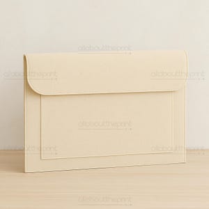 May include: A cream-colored document folder with a flap closure. The folder has a rectangular design with a stitched border and a pocket on the front. The text "allabouttheprint" is printed on the folder.