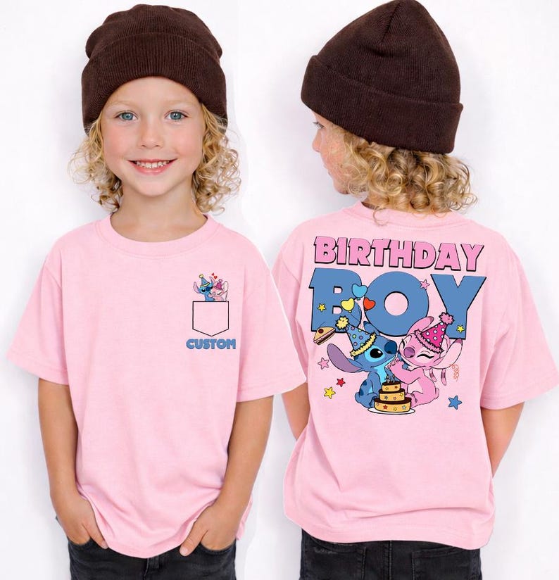 May include: Pink short-sleeved t-shirt with a pocket design featuring cartoon characters. The back of the shirt says "BIRTHDAY BOY" with cartoon characters and a cake. The word "CUSTOM" is printed on the pocket.