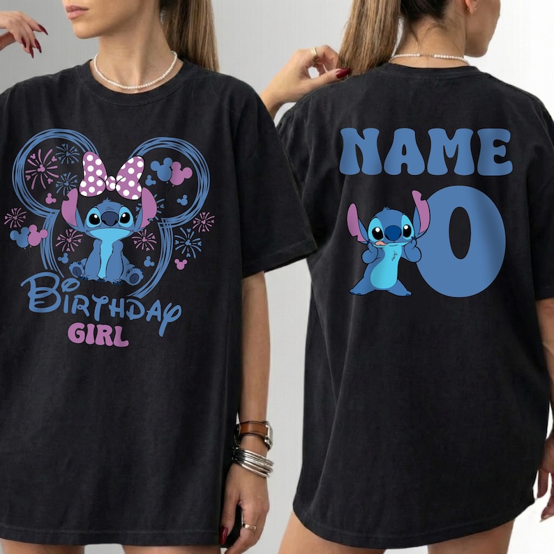 May include: Black t-shirt featuring a blue cartoon character with a bow and the text "Birthday Girl" on the front. The back of the shirt has the word "NAME" and the number "0" with the same cartoon character.