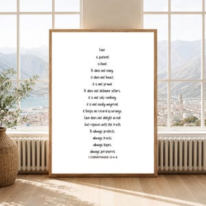 May include: A rectangular wall art print in a light wood frame featuring black text on a white background. The text reads: Love is patient, is kind. It does not envy, it does not boast, it is not proud. It does not dishonor others, it is not self-seeking, it is not easily angered, it keeps no record of wrongs. Love does not delight in evil but rejoices with the truth. It always protects, always trusts, always hopes, always perseveres. 1 CORINTHIANS 13:4-8.