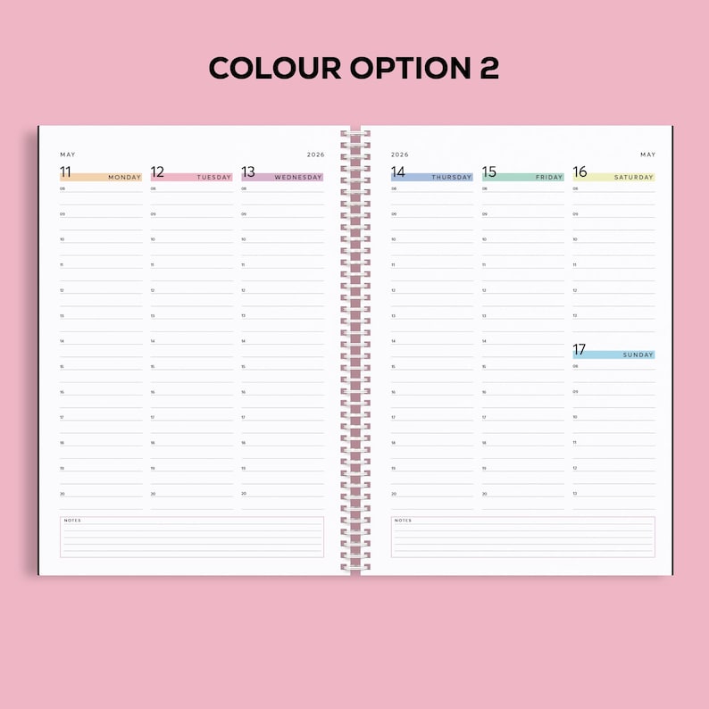 May include: Open spiral-bound planner with a pink cover. The interior pages are white with a weekly layout, featuring dates and space for notes. The text "COLOUR OPTION 2" is at the top. The dates of May 11-17, 2026 are visible.