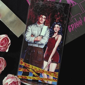 May include: A bookmark featuring a couple with a chef and a woman in a red dress, holding a cleaver and a knife. The background has a spiderweb design and crime scene tape. The text "Чорна" and "БРІНН" are visible.