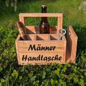 Op de afbeelding: Een witte keramische mok met een zwart handvat en de tekst "But First, Coffee" in een zwarte, vette letter. De mok staat op een wit oppervlak. De mok is 10 cm hoog.