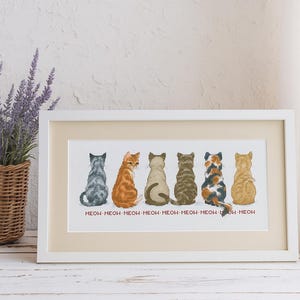 May include: Framed cross-stitch art featuring six cats viewed from the back, each with unique fur patterns and colors, including gray, orange, brown, and calico. The word "MEOW" is stitched below each cat. The artwork is displayed in a white frame.