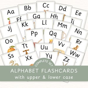 May include: A collection of alphabet flashcards with upper and lower case letters. Each card features a letter and a watercolor illustration. The cards are arranged in a scattered layout, with the text "COMPLETE SET" and "ALPHABET FLASHCARDS" visible.