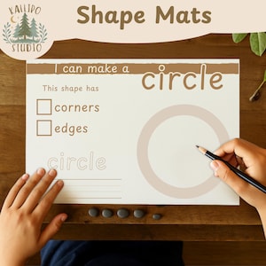 May include: A shape mat with the text "Shape Mats" and "I can make a circle". The mat has a circle outline, space for writing, and checkboxes for corners and edges. A hand is holding a pencil.