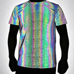 May include: A short-sleeved, iridescent t-shirt with a snakeskin pattern. The shirt reflects a spectrum of colors, including green, blue, yellow, and purple. The design gives the shirt a unique, eye-catching appearance. The shirt is a crew neck style.