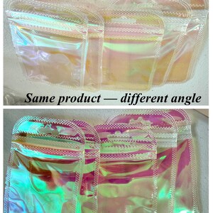 May include: Several iridescent, resealable pouches are displayed, showcasing a holographic effect with a range of colors. The pouches have a zipper closure and a small hole at the top. The text "Same product - different angle" is visible at the bottom.