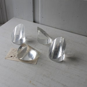 May include: Four clear acrylic geometric shapes, possibly for display or decoration.