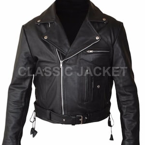 May include: Black leather jacket with a classic biker style. Features a notched collar, asymmetrical zipper closure, multiple pockets, and a belt at the waist. The text "CLASSIC JACKET" is printed on the front.