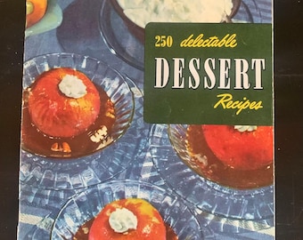 May include: A vintage cookbook cover with the title "250 delectable DESSERT Recipes". The cover features a close-up of three desserts in glass dishes on a blue and white tablecloth.