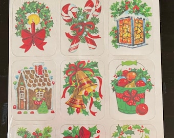 May include: Sheet of 36 self-adhesive Christmas seals. The red header reads "CHRISTMAS SEALS". The seals feature festive illustrations of wreaths, candy canes, a lantern, a gingerbread house, bells, a basket of fruit, pine cones, and a red cardinal.