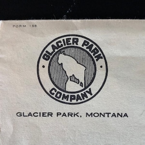 May include: Black and white logo on a white background. The logo is a circle with the text "Glacier Park Company" and a mountain goat inside. The text "Glacier Park, Montana" is below the logo.