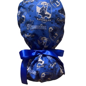 May include: A blue Ravenclaw scrub cap with a matching blue satin ribbon. The cap features a repeating pattern of the Ravenclaw crest, eagle, and text. The cap is designed to be worn during medical procedures.