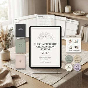May include: A digital planner titled The Complete Life Organization System 2027 with a line art eucalyptus branch, accompanied by three cover variations, a sticker pack, and calendar pages displayed on a tablet screen with a stylus.