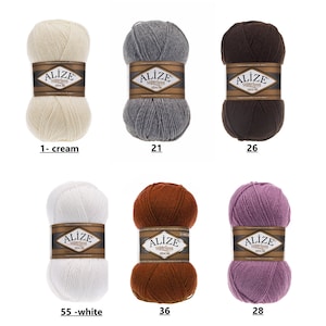May include: Six skeins of yarn in different colors, including cream, gray, brown, white, orange, and purple. Each skein has a label that says "Alize superlana zincir".
