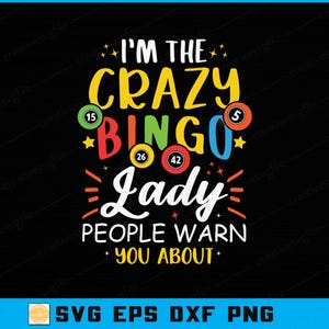 May include: Black graphic design with the text "I'M THE CRAZY BINGO Lady PEOPLE WARN YOU ABOUT". The design includes bingo balls with numbers and star accents in yellow, red, green, and blue.