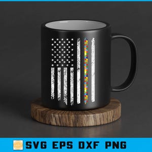 May include: Black coffee mug with a distressed American flag design and a puzzle piece stripe. The mug is on a round wooden coaster. The design features white stars and stripes, and a colourful puzzle piece stripe.