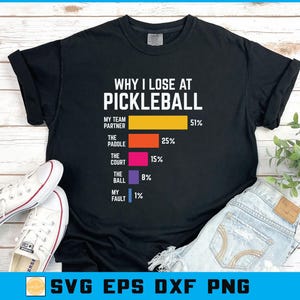 May include: Black t-shirt with the text "WHY I LOSE AT PICKLEBALL" and a bar graph showing the reasons for losing. The reasons include "My Team Partner", "The Paddle", "The Court", "The Ball", and "My Fault". White trainers and blue jeans are also in the image.