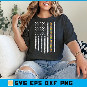 May include: Black t-shirt with a distressed American flag design and a vertical stripe of colourful puzzle pieces. The shirt has short sleeves and is worn with blue jeans. The text "SVG EPS DXF PNG" is at the bottom.