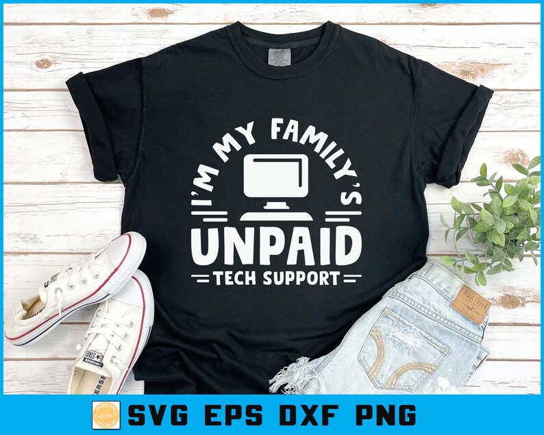 May include: Black t-shirt with the text "I'M MY FAMILY'S UNPAID TECH SUPPORT" in white. The design includes a computer monitor graphic. White sneakers and blue jeans are also in the image.