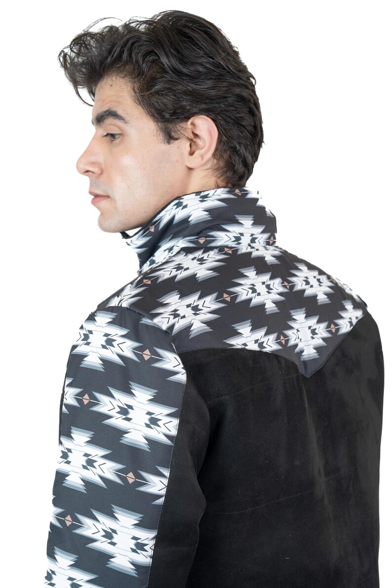 May include: Black and white patterned shirt with a suede-like black panel. The shirt features a geometric design on the collar and upper back. The model is facing away from the camera.