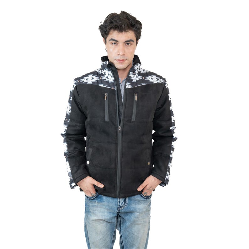 May include: Black jacket with a geometric pattern on the shoulders and sleeves. The jacket has a zipper closure and two front pockets. The model is wearing blue jeans. The jacket is made of a suede-like material.