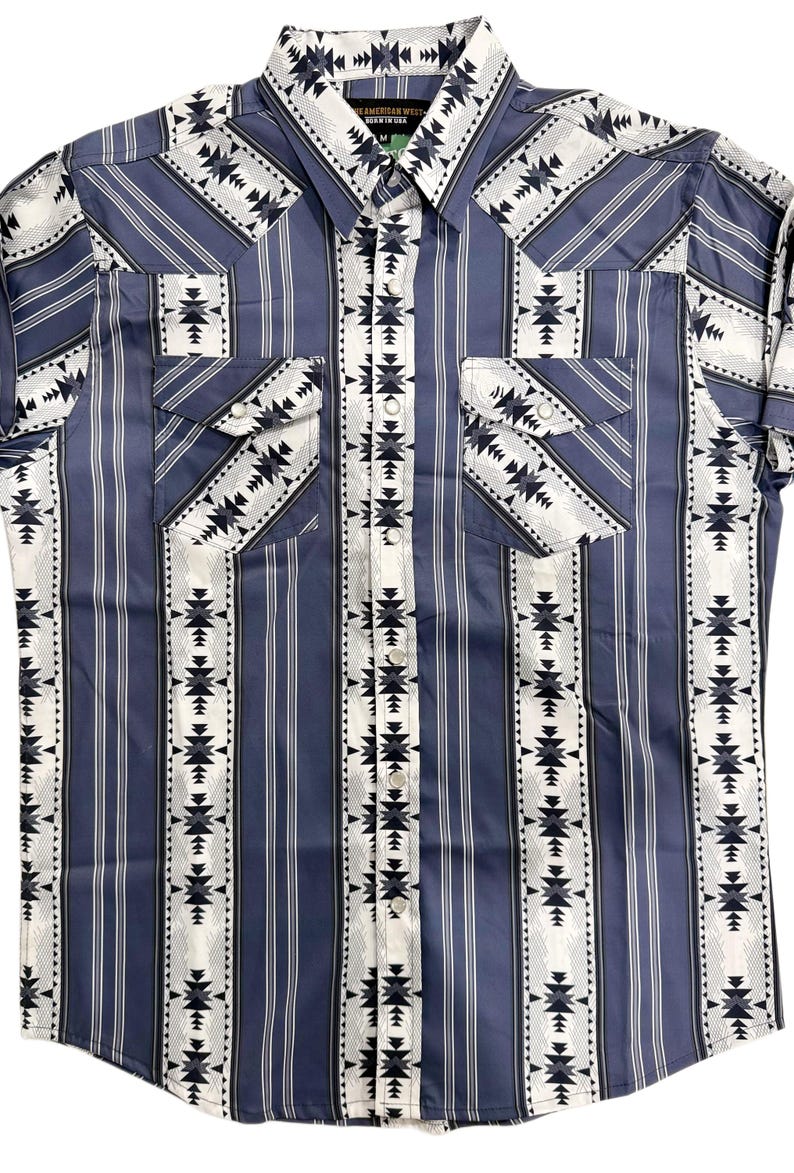 May include: Blue and white patterned button-up shirt with vertical stripes and geometric designs. Features two chest pockets and a collared neckline. The shirt is a medium size.