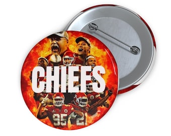 May include: A round button featuring a collage of football players and coaches in red and gold, with the word "CHIEFS" in large white letters. The button has a silver pin back and a red and white striped edge.